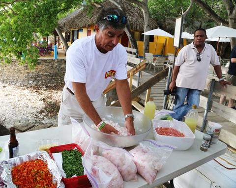 Lad Akins, one of the authors of the Lionfish Cookbook, demonstrates the proper way to prepare ceviche. The recipe calls for tomatoes, scotch bonnet peppers, onions, limes, and cilantro.