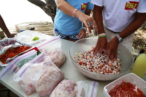 Jaclyn, a Florida teacher and trip participant, assists Lad with ceviche preparations.