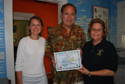 Leda Cunningham and Paul Humann present the Congresswoman with certificate of appreciation for her commitment to conservation.